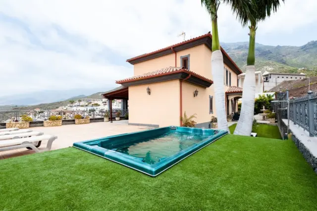 Villa for sale in Roques del Conde, Costa Adeje. Located in one of the most elevated areas of Costa Adeje, with sea views and surrounded by properties of the same style, this exclusive zone is situated in the south of Tenerife. The property is distributed across three levels: the ground floor features a living room, lounge, independent kitchen, one double bedroom, a bathroom, and a separate toilet. On the upper floor, there are two en-suite bedrooms with built-in wardrobes, a lounge, and a terrace. The basement level offers a large rustic/colonial-style space with stone finishes, barbecue area, air conditioning, and a lovely wine cellar. There is also parking for four cars and an annexed storage room. The entire house is surrounded by multiple terraces, gardens, a solarium, and a jacuzzi with spectacular sea views. A designated area is prepared for installing a pool if desired. The type of construction and materials used are high quality, evident at first glance: marble, natural stone, ceramics, treated wood, aluminum joinery with double glazing, etc. Don’t miss the opportunity to see it and feel it with your own eyes; you won’t regret it if you’re looking for a property of this style with guaranteed lifelong sea views. Just 10 minutes from the beach and the centers of Las Américas and Los Cristianos. The Roque del Conde area is a residential neighborhood known for its luxury properties and tranquility.[IW]