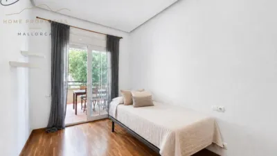 Ground floor apartment with two terraces, swimming pools, parking and storage room in La Bonanova. Living in La Bonanova means enjoying one of the most valued residential areas in Palma, combining tranquility, good transport links and proximity to all amenities. In this privileged setting we find this attractive ground floor apartment with two bedrooms and two terraces, located in a well-kept high-end residential complex. The property stands out for its outdoor spaces, its good layout and the quality of its finishes, making it an excellent option both as a main residence and as a second home in Mallorca. The interior is arranged with two bedrooms, both with direct access to the terrace, and two bathrooms. It also features built-in wardrobes and parquet flooring, adding warmth and functionality to the different rooms. The living room connects to the kitchen, creating a comfortable and practical day zone, and the apartment also includes a separate laundry area. One of its main attractions is its two private terraces. The terrace connected directly to the living room offers space for an outdoor dining area, perfect for enjoying dinners, gatherings with friends or simply relaxing outdoors. From here you can even admire the characteristic silhouette of Bellver Castle, adding special appeal to the surroundings. The property also has a second terrace, connected to the ground floor, considerably expanding the possibilities for enjoying the outdoors for much of the year. The residential complex offers well-maintained communal areas with two large swimming pools, perfectly kept gardens, rest areas with benches and various spaces designed to enjoy the environment and leisure time with family. The apartment also includes a parking space and storage room, two particularly practical and valued features in this area of Palma. La Bonanova is one of the residential areas with the highest demand in the city thanks to its tranquility, excellent location and quick connections to the main access routes to Palma. Its proximity to Queens College is also noteworthy, making this location especially interesting for families and international buyers looking to establish their residence near an international school. A property particularly suited for those seeking quality of life, outdoor spaces, communal areas and a privileged location in Palma de Mallorca, whether as a main residence or second home. Contact us for more information and to view this property and its terraces in person in one of the most attractive areas of La Bonanova. The price includes the agency fees, payable by the seller. It does not include taxes or purchase costs — ITP or VAT/AJD, notary and registration — which will be borne by the buyer. Their amount will depend on the value of the transaction and the personal circumstances of the purchaser. photo 8
