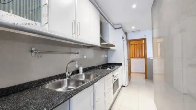Ground floor apartment with two terraces, swimming pools, parking and storage room in La Bonanova. Living in La Bonanova means enjoying one of the most valued residential areas in Palma, combining tranquility, good transport links and proximity to all amenities. In this privileged setting we find this attractive ground floor apartment with two bedrooms and two terraces, located in a well-kept high-end residential complex. The property stands out for its outdoor spaces, its good layout and the quality of its finishes, making it an excellent option both as a main residence and as a second home in Mallorca. The interior is arranged with two bedrooms, both with direct access to the terrace, and two bathrooms. It also features built-in wardrobes and parquet flooring, adding warmth and functionality to the different rooms. The living room connects to the kitchen, creating a comfortable and practical day zone, and the apartment also includes a separate laundry area. One of its main attractions is its two private terraces. The terrace connected directly to the living room offers space for an outdoor dining area, perfect for enjoying dinners, gatherings with friends or simply relaxing outdoors. From here you can even admire the characteristic silhouette of Bellver Castle, adding special appeal to the surroundings. The property also has a second terrace, connected to the ground floor, considerably expanding the possibilities for enjoying the outdoors for much of the year. The residential complex offers well-maintained communal areas with two large swimming pools, perfectly kept gardens, rest areas with benches and various spaces designed to enjoy the environment and leisure time with family. The apartment also includes a parking space and storage room, two particularly practical and valued features in this area of Palma. La Bonanova is one of the residential areas with the highest demand in the city thanks to its tranquility, excellent location and quick connections to the main access routes to Palma. Its proximity to Queens College is also noteworthy, making this location especially interesting for families and international buyers looking to establish their residence near an international school. A property particularly suited for those seeking quality of life, outdoor spaces, communal areas and a privileged location in Palma de Mallorca, whether as a main residence or second home. Contact us for more information and to view this property and its terraces in person in one of the most attractive areas of La Bonanova. The price includes the agency fees, payable by the seller. It does not include taxes or purchase costs — ITP or VAT/AJD, notary and registration — which will be borne by the buyer. Their amount will depend on the value of the transaction and the personal circumstances of the purchaser. photo 17