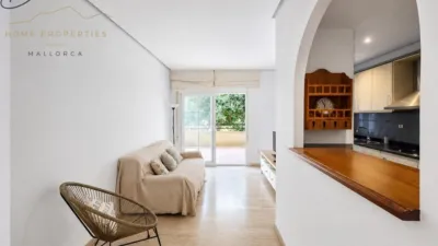 Ground floor apartment with two terraces, swimming pools, parking and storage room in La Bonanova. Living in La Bonanova means enjoying one of the most valued residential areas in Palma, combining tranquility, good transport links and proximity to all amenities. In this privileged setting we find this attractive ground floor apartment with two bedrooms and two terraces, located in a well-kept high-end residential complex. The property stands out for its outdoor spaces, its good layout and the quality of its finishes, making it an excellent option both as a main residence and as a second home in Mallorca. The interior is arranged with two bedrooms, both with direct access to the terrace, and two bathrooms. It also features built-in wardrobes and parquet flooring, adding warmth and functionality to the different rooms. The living room connects to the kitchen, creating a comfortable and practical day zone, and the apartment also includes a separate laundry area. One of its main attractions is its two private terraces. The terrace connected directly to the living room offers space for an outdoor dining area, perfect for enjoying dinners, gatherings with friends or simply relaxing outdoors. From here you can even admire the characteristic silhouette of Bellver Castle, adding special appeal to the surroundings. The property also has a second terrace, connected to the ground floor, considerably expanding the possibilities for enjoying the outdoors for much of the year. The residential complex offers well-maintained communal areas with two large swimming pools, perfectly kept gardens, rest areas with benches and various spaces designed to enjoy the environment and leisure time with family. The apartment also includes a parking space and storage room, two particularly practical and valued features in this area of Palma. La Bonanova is one of the residential areas with the highest demand in the city thanks to its tranquility, excellent location and quick connections to the main access routes to Palma. Its proximity to Queens College is also noteworthy, making this location especially interesting for families and international buyers looking to establish their residence near an international school. A property particularly suited for those seeking quality of life, outdoor spaces, communal areas and a privileged location in Palma de Mallorca, whether as a main residence or second home. Contact us for more information and to view this property and its terraces in person in one of the most attractive areas of La Bonanova. The price includes the agency fees, payable by the seller. It does not include taxes or purchase costs — ITP or VAT/AJD, notary and registration — which will be borne by the buyer. Their amount will depend on the value of the transaction and the personal circumstances of the purchaser. photo 5