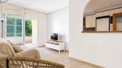 Ground floor apartment with two terraces, swimming pools, parking and storage room in La Bonanova. Living in La Bonanova means enjoying one of the most valued residential areas in Palma, combining tranquility, good transport links and proximity to all amenities. In this privileged setting we find this attractive ground floor apartment with two bedrooms and two terraces, located in a well-kept high-end residential complex. The property stands out for its outdoor spaces, its good layout and the quality of its finishes, making it an excellent option both as a main residence and as a second home in Mallorca. The interior is arranged with two bedrooms, both with direct access to the terrace, and two bathrooms. It also features built-in wardrobes and parquet flooring, adding warmth and functionality to the different rooms. The living room connects to the kitchen, creating a comfortable and practical day zone, and the apartment also includes a separate laundry area. One of its main attractions is its two private terraces. The terrace connected directly to the living room offers space for an outdoor dining area, perfect for enjoying dinners, gatherings with friends or simply relaxing outdoors. From here you can even admire the characteristic silhouette of Bellver Castle, adding special appeal to the surroundings. The property also has a second terrace, connected to the ground floor, considerably expanding the possibilities for enjoying the outdoors for much of the year. The residential complex offers well-maintained communal areas with two large swimming pools, perfectly kept gardens, rest areas with benches and various spaces designed to enjoy the environment and leisure time with family. The apartment also includes a parking space and storage room, two particularly practical and valued features in this area of Palma. La Bonanova is one of the residential areas with the highest demand in the city thanks to its tranquility, excellent location and quick connections to the main access routes to Palma. Its proximity to Queens College is also noteworthy, making this location especially interesting for families and international buyers looking to establish their residence near an international school. A property particularly suited for those seeking quality of life, outdoor spaces, communal areas and a privileged location in Palma de Mallorca, whether as a main residence or second home. Contact us for more information and to view this property and its terraces in person in one of the most attractive areas of La Bonanova. The price includes the agency fees, payable by the seller. It does not include taxes or purchase costs — ITP or VAT/AJD, notary and registration — which will be borne by the buyer. Their amount will depend on the value of the transaction and the personal circumstances of the purchaser. photo 12