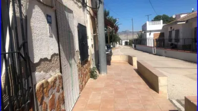 House for sale in La Matanza, Orihuela. This property comprises a residential house of 152 m² and a separate commercial unit with storage space of 142 m² built area, both situated on a 1000 m² plot. The residence features three double bedrooms, one single bedroom, a living room, a sitting room, an equipped kitchen, one bathroom, and a patio with a laundry area. The commercial and storage building is fully finished. Interior joinery is made of sapeli wood, it has an east-facing orientation, porcelain tile flooring, and exterior joinery combining aluminium and wood. Extras include water, electricity, furniture, terrace, and storage room. Located close to medical centres, rural amenities, supermarkets, and pharmacies. photo 26