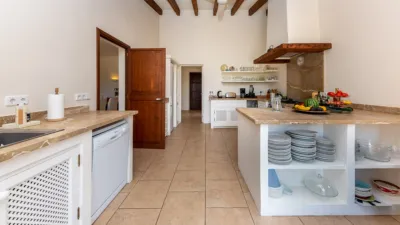 Luxury rural finca in one of Pollença’s most sought-after areas. Built in 2003, this property sits on a plot of 53,600m² with approximately 540m² of built space. The main house features a bedroom on the ground floor, a living room with a fireplace, a separate dining room, and a large kitchen with a pantry and laundry room, all overlooking the garden. Access to the garage, which can accommodate two large cars, is also on this level. photo 12
