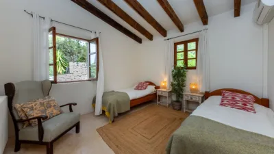 Luxury rural finca in one of Pollença’s most sought-after areas. Built in 2003, this property sits on a plot of 53,600m² with approximately 540m² of built space. The main house features a bedroom on the ground floor, a living room with a fireplace, a separate dining room, and a large kitchen with a pantry and laundry room, all overlooking the garden. Access to the garage, which can accommodate two large cars, is also on this level. photo 21