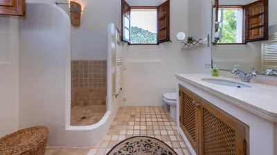 Luxury rural finca in one of Pollença’s most sought-after areas. Built in 2003, this property sits on a plot of 53,600m² with approximately 540m² of built space. The main house features a bedroom on the ground floor, a living room with a fireplace, a separate dining room, and a large kitchen with a pantry and laundry room, all overlooking the garden. Access to the garage, which can accommodate two large cars, is also on this level. photo 22