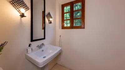 Luxury rural finca in one of Pollença’s most sought-after areas. Built in 2003, this property sits on a plot of 53,600m² with approximately 540m² of built space. The main house features a bedroom on the ground floor, a living room with a fireplace, a separate dining room, and a large kitchen with a pantry and laundry room, all overlooking the garden. Access to the garage, which can accommodate two large cars, is also on this level. photo 25