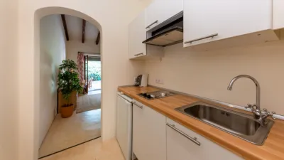 Luxury rural finca in one of Pollença’s most sought-after areas. Built in 2003, this property sits on a plot of 53,600m² with approximately 540m² of built space. The main house features a bedroom on the ground floor, a living room with a fireplace, a separate dining room, and a large kitchen with a pantry and laundry room, all overlooking the garden. Access to the garage, which can accommodate two large cars, is also on this level. photo 26