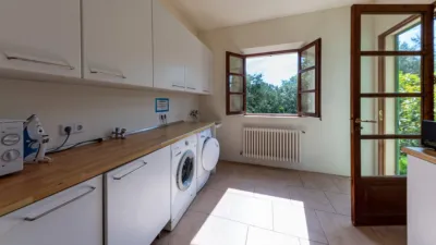 Luxury rural finca in one of Pollença’s most sought-after areas. Built in 2003, this property sits on a plot of 53,600m² with approximately 540m² of built space. The main house features a bedroom on the ground floor, a living room with a fireplace, a separate dining room, and a large kitchen with a pantry and laundry room, all overlooking the garden. Access to the garage, which can accommodate two large cars, is also on this level. photo 28