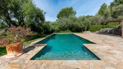 Luxury rural finca in one of Pollença’s most sought-after areas. Built in 2003, this property sits on a plot of 53,600m² with approximately 540m² of built space. The main house features a bedroom on the ground floor, a living room with a fireplace, a separate dining room, and a large kitchen with a pantry and laundry room, all overlooking the garden. Access to the garage, which can accommodate two large cars, is also on this level. photo 36