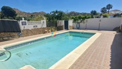Villa for sale in Los Carrascos, Arboleas. A spacious 3-bedroom villa located in the highly sought-after area of Los Carrascos, Arboleas, offering privacy, generous outdoor areas and a peaceful setting. The property is fully enclosed with a gated entrance. Situated on a quiet side street, it borders an open plot. The house comprises 3 bedrooms, one with an en-suite bathroom, and air conditioning installed in 5 rooms. It features a large living room with a fireplace, a separate dining area, and a fully equipped kitchen. A spacious enclosed external terrace provides additional space for relaxation and entertaining, opening directly onto the pool area. At the rear, there is a large terrace adjacent to the swimming pool, complete with an outdoor shower. To the front, another terrace benefits from a pergola, while the side of the house includes a private, walled garden with mature flowers. There is also a garden storage room. In the front of the property, a driveway offers parking space for one car. The villa is sold unfurnished, although the owner is willing to negotiate on furniture if required. The property requires some improvements and redecoration, though these are purely cosmetic. The owner is open to offers, making this an excellent opportunity for those looking to personalise and adapt a villa to their taste. A lovely home in a tranquil location, featuring a private pool, expansive terraces and plenty of potential. photo 3