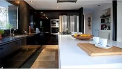 Detached house for sale in Begues, located in the Mas Ferrer area. Plot size: 1,364m² with a built-up area of 364m². Features 5 bedrooms (1 suite with dressing room), 3 bathrooms (2 with double shower and 1 with jacuzzi). Santos kitchen equipped with Neff appliances. Spacious living-dining room with library area and billiard room. Parquet flooring, aluminium windows, heating and air conditioning, reinforced door. Large garden with pool and chill-out area with barbecue. Solar panels included. The property is in very good condition and situated in a quiet location. photo 17