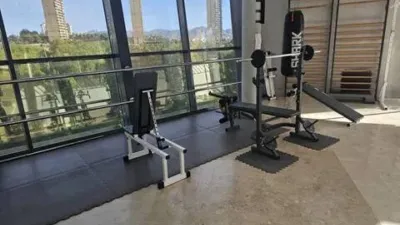 Loft for sale in Terramar Community, Benidorm. Located in Poniente, south-facing. €3,125/m². Opposite the Intempo building in Benidorm. Surrounded by green areas and a golf course. 2 bathrooms: 1 WC + 1 shower room. Walk-in closet. Fully equipped kitchen with high-quality Bosch appliances. The kitchen and dining area form a comfortable and cozy loft, complete with a leather sofa bed. Terrace with beautiful exterior views. Fully external apartment with plenty of natural light. Includes parking space. Storage room (2 × 2 m²). Elevator. Air conditioning-heating. 3 outdoor pools. 1 indoor heated pool. Full gym with showers. 4 WCs. 2 tennis-padel courts. Ping-pong table. Walking paths within the complex with benches. Alarm system installed. photo 24