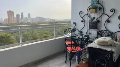 Loft for sale in Terramar Community, Benidorm. Located in Poniente, south-facing. €3,125/m². Opposite the Intempo building in Benidorm. Surrounded by green areas and a golf course. 2 bathrooms: 1 WC + 1 shower room. Walk-in closet. Fully equipped kitchen with high-quality Bosch appliances. The kitchen and dining area form a comfortable and cozy loft, complete with a leather sofa bed. Terrace with beautiful exterior views. Fully external apartment with plenty of natural light. Includes parking space. Storage room (2 × 2 m²). Elevator. Air conditioning-heating. 3 outdoor pools. 1 indoor heated pool. Full gym with showers. 4 WCs. 2 tennis-padel courts. Ping-pong table. Walking paths within the complex with benches. Alarm system installed. photo 28