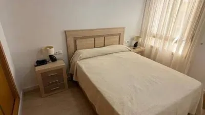 Duplex penthouse in Plaza Porticada, with 119 m² built area, 3 bedrooms, 2 bathrooms, good condition, floor 4, 2 wardrobes, 1 terrace(s), 25 m² of terrace, French kitchen, lift, 2006, green areas, 4 floors in the building, top floor, pets accepted. Duplex penthouse in Guardamar del Segura just 200m from the beach. The main floor features a living-dining room with side sea views, French kitchen, two bedrooms with fitted wardrobes, one bathroom. An internal staircase leads to the upper floor where there is a spacious bedroom with an en-suite bathroom and a private solarium of about 25m² with sea views. 119 m². There is also direct access to the communal solarium. In 2023, sold furnished and equipped. Close to all amenities. photo 16